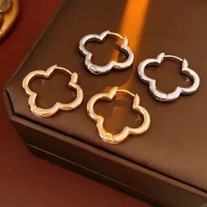 Polished hollow clover hoop earrings in gold and silver finish for luxury fashion