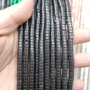 Close-up of polished black natural stone cylindrical spacer beads for DIY jewelry making