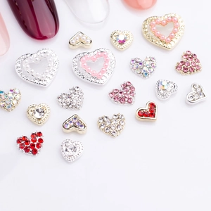 Macro shot of assorted alloy heart nail charms with rhinestones and faux pearls