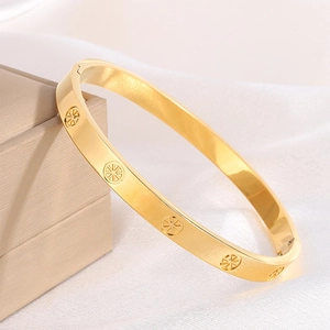 Luxury gold plated stainless steel bangle featuring sunburst engravings on white silk