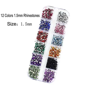 Macro view of 1.5mm 12-color flatback nail rhinestones in a rectangular plastic grid box