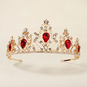 Luxurious vintage gold crown featuring large red teardrop gems and sparkling white crystals