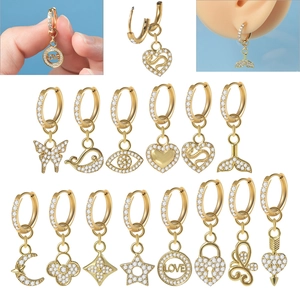 Detailed close-up of golden stainless steel hoop earrings with micro-inlaid zircon charms
