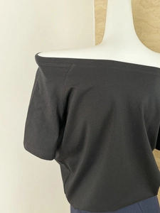 Detail of off-shoulder neckline and knitted texture on black BF style loose t-shirt
