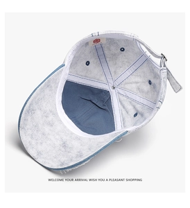 Detailed interior of blue denim baseball cap showing reinforced seams and adjustable metal buckle