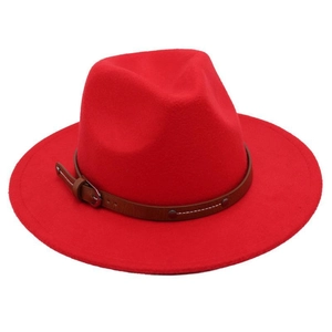 Detail of red felt fedora hat featuring a brown leather decorative belt and metal buckle