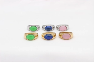 Flat lay of oval gemstone rings in gold and silver steel with green, blue and pink stones