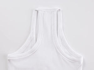 Detailed view of white ribbed knit tank top showing high-quality stitching and fabric texture