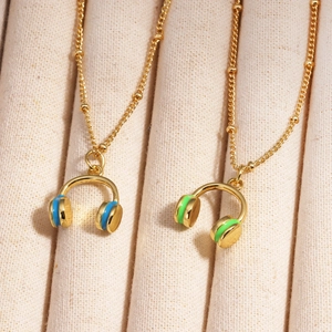 Detailed view of gold-plated headphone pendants with blue and green enamel on fine chains