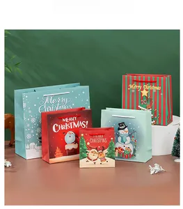 Detailed view of various Christmas paper gift bags with festive patterns and rope handles