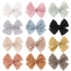 12-piece set of lace bow hair clips for infants with intricate floral embroidery patterns