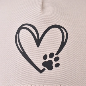 Beige cotton baseball cap featuring a black heart outline with a paw print design