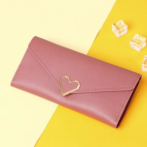 Detail of dusty pink long wallet with golden heart-shaped clasp on high-quality PU leather