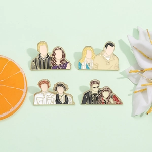 Set of four Twilight movie character enamel pins on light green backdrop with petals