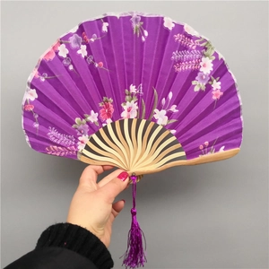 Japanese purple silk folding fan with pink floral pattern and bamboo frame with tassel