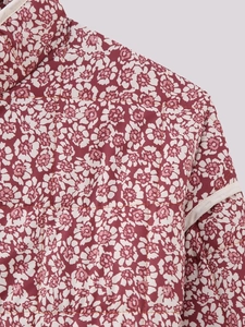 Detail shot of the quilted floral jacket featuring white flowers and a stand collar