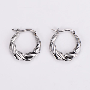 Close-up of silver twisted hoop earrings showing refined metallic texture and details