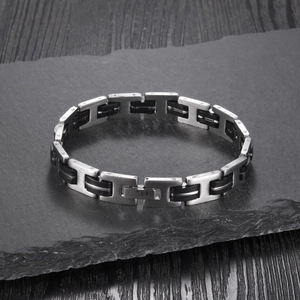 Close-up of vintage men's silicone bracelet with brushed stainless steel links and rivets