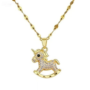 Macro shot of gold rocking horse pendant with pavé set zircon crystals on fine wave chain