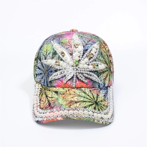Detailed close-up of a floral baseball cap with colorful botanical prints and rhinestones