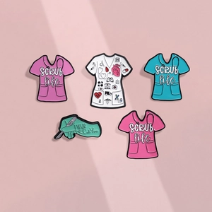 Set of 5 medical enamel pins with scrub suit designs and healthcare quotes on pink background