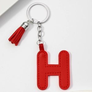 Close-up of red PU leather letter H keychain featuring matching red tassel and silver ring
