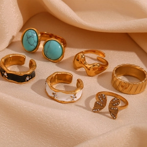 Set of 6 gold rings featuring butterfly shape, turquoise stones and enamel details