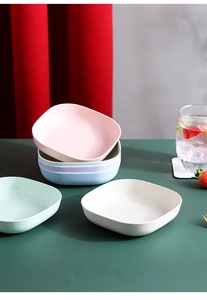 Set of four square wheat straw snack plates in pastel pink, blue, green, and beige colors