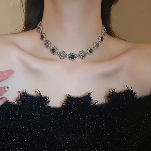 Vintage gold flower choker necklace with blue gemstones on elegant model