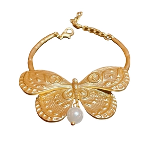 Exaggerated golden butterfly bracelet with pearl accent and adjustable lobster clasp chain