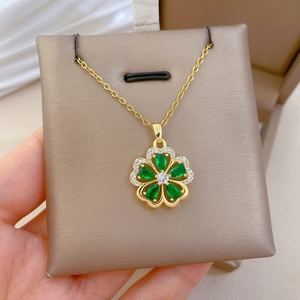 Close-up of titanium necklace featuring a luxury green five-leaf flower pendant with crystals