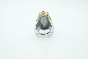 Macro detail of lion head ring showing gold and silver contrast and relief textures
