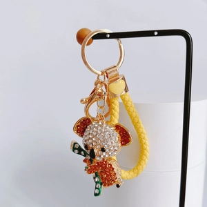 Detailed view of koala rhinestone keychain with yellow woven rope and golden metal clasp