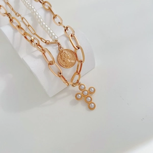 Double-layered gold chain necklace with faux pearls, portrait coin and cross pendants