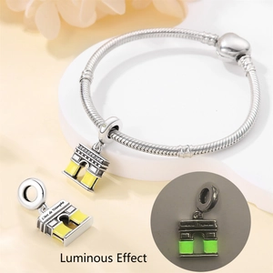 Detailed view of luminous Arc de Triomphe charm showing the glow effect in silver finish