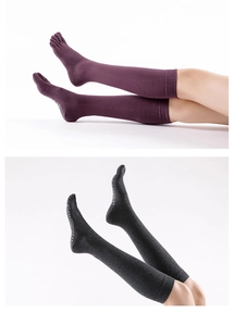 Detail of anti-slip dots on over-knee five-toe yoga socks in purple and grey