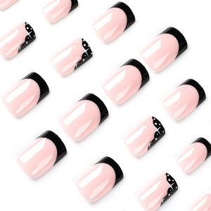 Short square press-on nails with pink base, black French tips and white star patterns