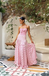 Detail of red polka dot tiered maxi dress with ruffled hem in Mediterranean setting