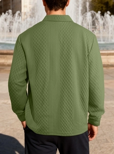 Dettaglio della polo in maglia jacquard verde con motivi geometrici in rilievo