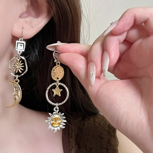Vintage asymmetrical sun and moon drop earrings in gold and silver mixed metal finish