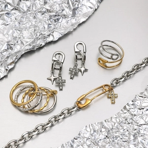 Luxury titanium steel jewelry set featuring safety pin motifs with cross and star charms