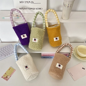 Detailed close-up of colorful plush water bottle bags with checkered handles and cat patch