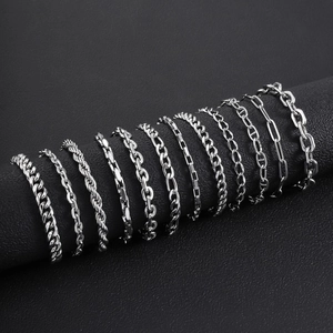 Classic silver stainless steel Cuban link chains for men displayed on black leather background