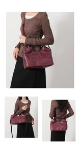 Macro detail of wine red soft leather handbag with reinforced stitching and metal hardware