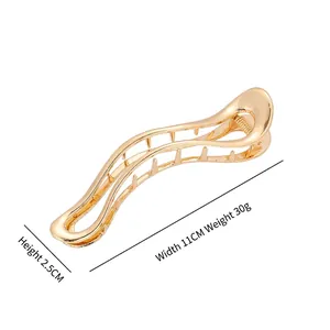 Large golden wave-shaped metal hair claw clip with 11cm width and hollow design