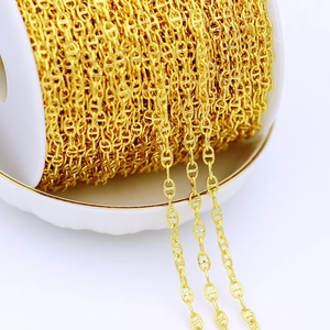 Close-up of 18K gold-plated brass H-link anchor chain on a white plastic spool for DIY