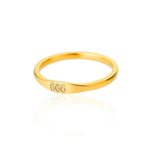 Detailed macro view of gold-plated stainless steel ring with 666 angel number engraving