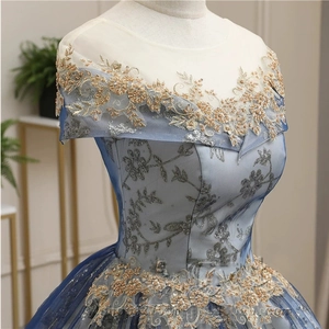 Detailed close-up of blue evening gown with gold sequin embroidery and floral mesh lace