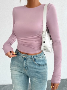 Detail of pink slim-fit long sleeve knitted top with side ruched texture on the waist