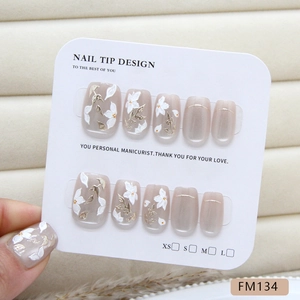 Handmade press-on nails with white 3D flowers, golden leaf foil and cat eye finish